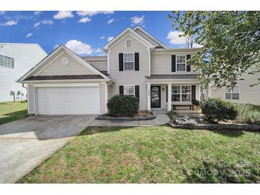 Charming two-story home with a well-manicured lawn, attached garage, and inviting front porch with black shutters at 257 Notable Ln, Rock Hill, SC 29732