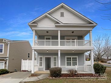 Charming two-story home featuring double porches, white railings, and a well-maintained front yard at 3937 Northerly Island Ct, Gastonia, NC 28056