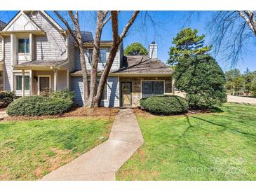 Charming townhome with stone accents, manicured lawn, and inviting walkway leading to the front door at 4139 N Course Dr, Charlotte, NC 28277