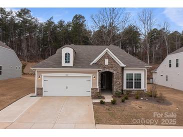 Inviting single-Gathering home showcases stone detailing, a two-car garage, and well-maintained landscaping at 4720 Maiden Creek Way, Maiden, NC 28650