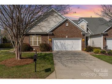 Charming brick home featuring a well-manicured lawn and a convenient two-car garage at 620 Amethyst Cir, Fort Mill, SC 29708