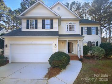 Charming two-story home with a well-manicured lawn, attached two-car garage, and classic design at 6318 Pink Dogwood Ln, Charlotte, NC 28262