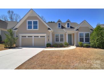 Charming single-Gathering home featuring a two-car garage, dormer windows, and a well-manicured lawn at 6521 Shoff Cir, Charlotte, NC 28215