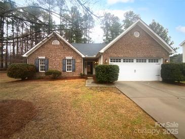 Charming brick home with blue shutters, a two-car garage, and a well-manicured front yard at 6809 Brancusi Ct, Charlotte, NC 28215