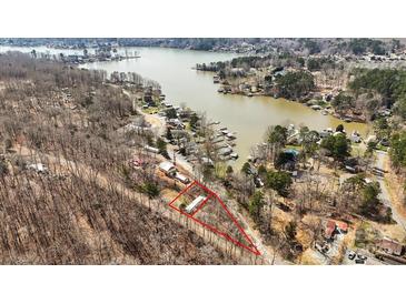 A stunning aerial view of a lakefront property highlighting its location and surrounding natural beauty at 144 Cherokee Ln, New London, NC 28127