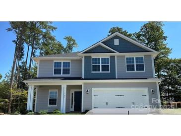 Charming two-story home featuring a covered entryway and a two-car garage at 149 High Rock Ct # 02, Statesville, NC 28677