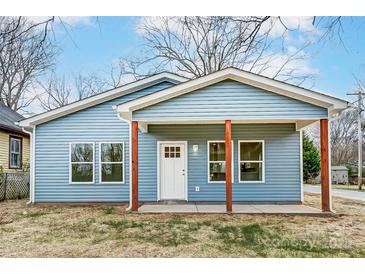 Charming blue house with a covered front porch, offering a welcoming entrance and curb appeal at 2313 N Main St, Kannapolis, NC 28081