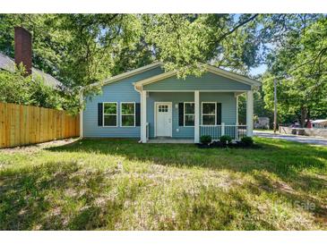Charming blue home with a welcoming front porch and black shutters at 2313 N Main St, Kannapolis, NC 28081