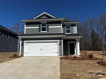 Charming two-story home featuring a two-car garage, stylish siding, and a well-maintained front yard at 311 Alden Ct, Shelby, NC 28152