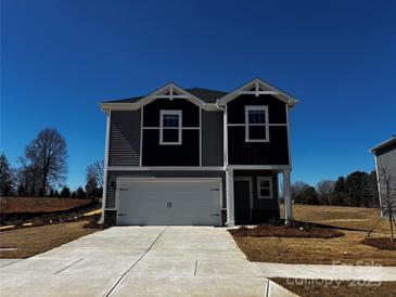 Charming two-story home featuring a two-car garage and modern architectural details at 414 Luna Ln, Shelby, NC 28152