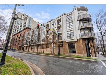 Modern building with balconies and brick accents on a street corner at 525 E 6Th St # 211, Charlotte, NC 28202