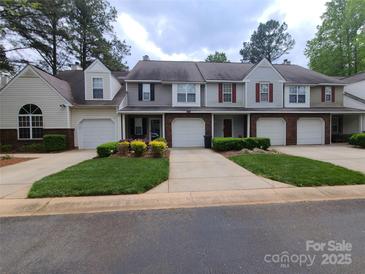 Charming townhome featuring manicured front lawn and single-car garage at 5963 Moose Ln, Charlotte, NC 28269