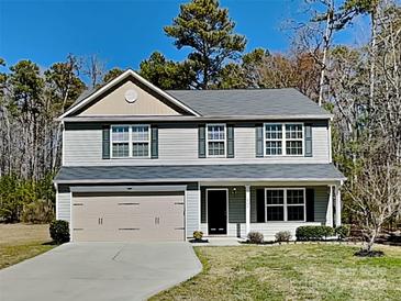 Charming two-story home with a two-car garage and well-manicured lawn at 600 Hunley St, Monroe, NC 28112