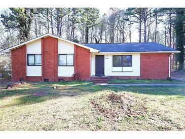 Cozy brick home with a charming front yard and dark trim windows at 6245 Snowcrest Ct, Charlotte, NC 28212