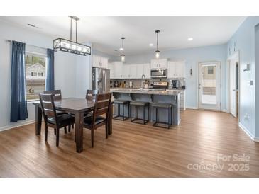 Bright kitchen features granite countertops, stainless steel appliances, gray cabinets and a dining area at 629 Gants Rd, York, SC 29745