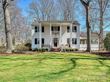Charming two-story home with a covered front porch, white pillars and a well-manicured lawn at 638 Forest Ln, Rock Hill, SC 29730