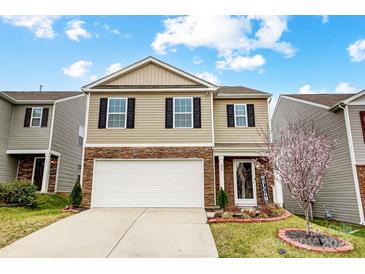 Charming two-story home with a welcoming front yard and a two car garage at 638 Nannyberry Ln, Concord, NC 28025