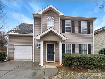 Charming two-story home with a welcoming entrance and attached garage for convenient parking at 8005 Mcgarry Trl, Charlotte, NC 28214