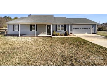 Charming home featuring a well-manicured lawn, covered porch, and attached garage, offering both curb appeal and practicality at 867 Meadow Hill Ct, Lincolnton, NC 28092