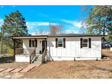 Charming single-story home with a white exterior, dark shutters, and a welcoming front porch with stone steps at 188 Bailey Rd, Mooresville, NC 28117