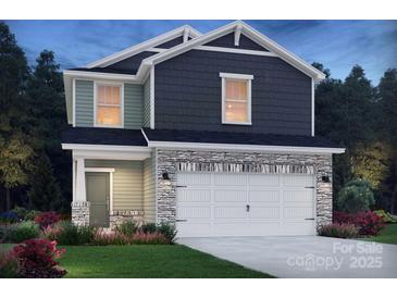 Two-story home features a stone-accented garage, light green siding, and stylish dark gray upper level shingles at 213 Alden Ct, Shelby, NC 28152