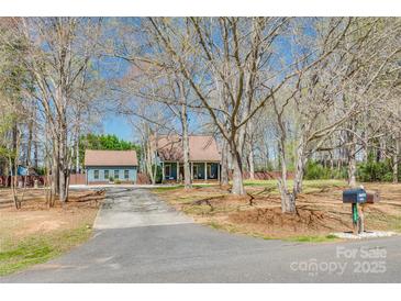Charming home with mature trees, long driveway, and a detached garage, blending comfort with natural beauty at 6688 Pine Forest Dr, York, SC 29745