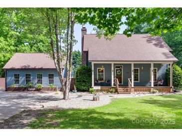 Charming home with a welcoming front porch, a well-maintained lawn, and a detached garage at 6688 Pine Forest Dr, York, SC 29745