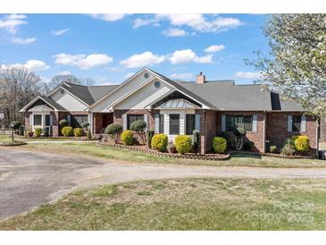 Beautiful brick home with well-maintained landscaping and mature trees at 1030 Hurley School Rd, Salisbury, NC 28147