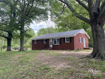 Charming brick home with black shutters, surrounded by mature trees in a peaceful setting at 1105 Carnation Ln, Sharon, SC 29742
