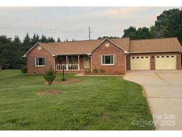 Charming single-story brick home features a well-manicured lawn and a welcoming front porch at 1922 Dogwood Flower Ln, Lincolnton, NC 28092