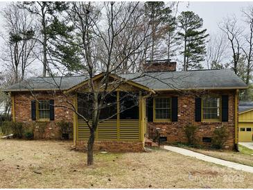 Charming brick home with a covered porch and mature trees at 300 Mcalway Rd, Charlotte, NC 28211