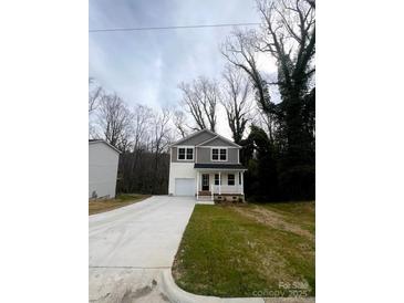 Charming two-story home with a well-manicured lawn and a concrete driveway at 423 Rocky Brook Dr, Shelby, NC 28150