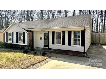 Charming one-story home with white siding, black shutters, and well-maintained landscaping at 4342 Valeview Ln, Charlotte, NC 28269