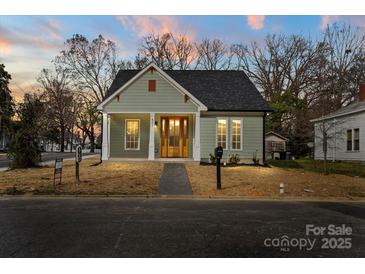 Charming single-story home with green siding and welcoming front porch at 501 Everette St, Monroe, NC 28112