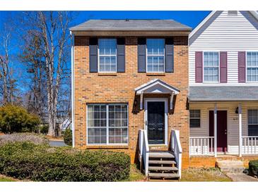 Charming brick two-story townhome with black shutters and a landscaped front yard at 6374 Windsor Gate Ln, Charlotte, NC 28215