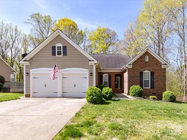 Charming home with a two-car garage, manicured lawn, and American flag displayed at 7507 Reedy Creek Rd, Charlotte, NC 28215