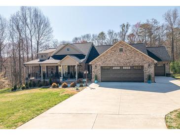 Stunning brick home with a welcoming front porch and spacious three-car garage on a sunny lot at 944 Clear Creek Cir, Lincolnton, NC 28092