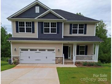 Charming two-story home featuring a covered porch, two-car garage, and beautiful contrasting siding at 145 High Rock Ct # 03, Statesville, NC 28677