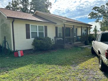 Charming single-story home with a covered front porch and inviting curb appeal at 211 Honeycutt Rd, Troutman, NC 28166