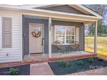 Inviting front porch with seating and a decorative wreath on the front door for a warm and welcoming entrance at 327 Berry St, Rock Hill, SC 29732