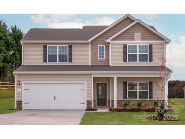Charming two-story home features a two-car garage, neutral siding, and black shutters on the windows at 3508 Narrow Ln, Charlotte, NC 28215