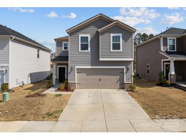 Charming gray two-story home featuring a two-car garage, landscaped yard, and inviting curb appeal at 2116 Belterra Dr, Charlotte, NC 28216