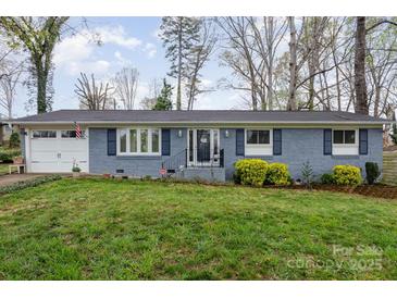 Charming single story blue brick home with a well-manicured lawn and appealing curb appeal at 2156 Flynn Dr, Gastonia, NC 28054