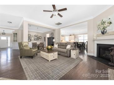 Open-concept living room featuring hardwood floors, neutral paint, and a cozy fireplace at 2455 Seagull Dr # 62, Denver, NC 28037