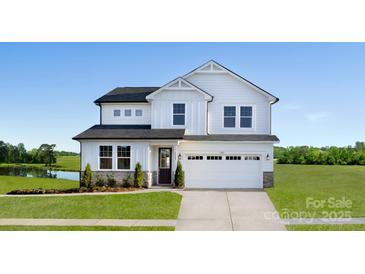 Charming two-story home with a manicured lawn and a two car garage in a serene neighborhood at 2640 Tillman N St, Monroe, NC 28112