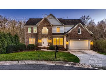 Charming two-story brick home with a well-manicured lawn and an attached two-car garage at 2835 Peverell Ln, Charlotte, NC 28270