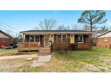 Charming single-story home with a cozy front porch and well-maintained lawn at 4914 Ridgeley Dr, Charlotte, NC 28208