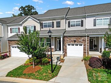 Charming townhome with stone accents, one-car garage, landscaped front yard, and inviting entry at 769 River Park Rd, Belmont, NC 28012