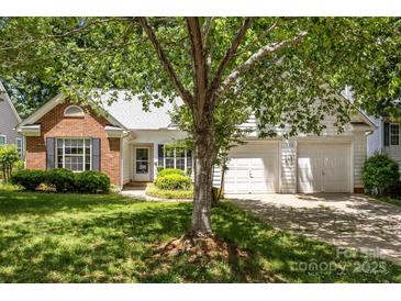 Charming single-Gathering home with brick and siding and a well-manicured lawn and two-car garage at 1286 Saint Katherines Way, Rock Hill, SC 29732