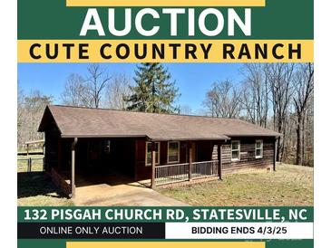 Charming ranch-style house featuring a cozy front porch and natural wood siding at 132 Pisgah Church Rd, Statesville, NC 28625